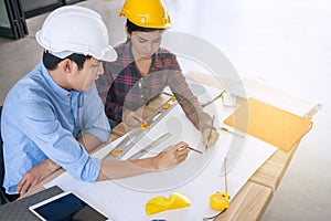 Professional male and female engineers working and discuss with