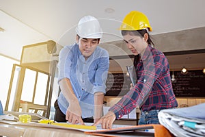 Professional male and female engineers working and discuss with