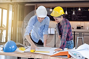 Professional male and female engineers working and discuss with