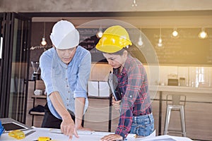 Professional male and female engineers working and discuss with