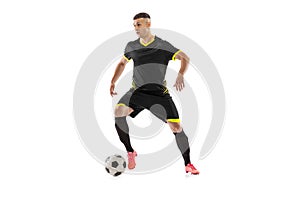 Professional male football soccer player in motion and action isolated on white studio background. Concept of sport