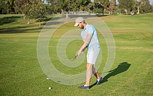 professional male golf player on professional course with green grass, summer