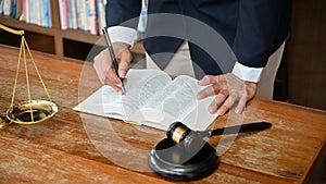 Professional male lawyer in formal suit working at his desk in his office room