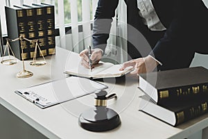 Professional male lawyers work at a law office There are scales, Scales of justice, judges gavel, and litigation documents.