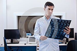 Professional male oncologist putting a diagnosis