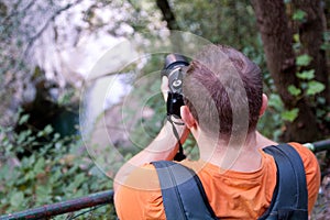 Professional male photographer in forest / Guys tourist in nature photography forest natural environment, enjoying beautiful day.