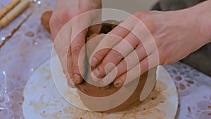 Professional male potter making ceramic jug