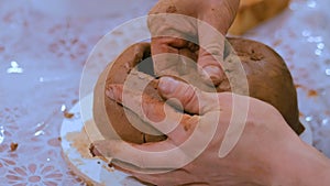 Professional male potter making ceramic jug