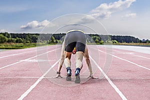 Professional male runner taking ready to start position