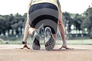 Professional male runner taking ready to start position