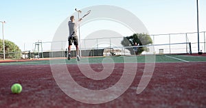 Professional male tennis player hits a tennis ball hard with backhand