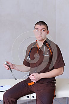 Professional male therapist looks at camera with smile and sitti
