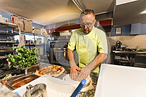 professional man cook working in the kitchen, italian restaurant