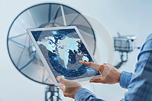 Man using a tablet with futuristic global network visualization