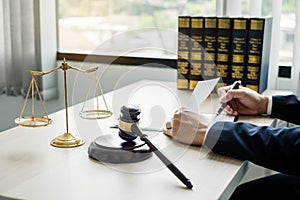 Professional man lawyers work at a law office There are scales, Scales of justice, judges gavel, and litigation documents.