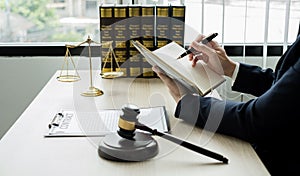 Professional man lawyers work at a law office There are scales, Scales of justice, judges gavel, and litigation documents.