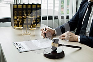 Professional man lawyers work at a law office There are scales, Scales of justice, judges gavel, and litigation documents.