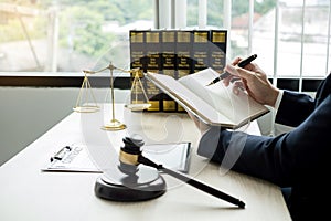 Professional man lawyers work at a law office There are scales, Scales of justice, judges gavel, and litigation documents.