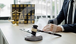 Professional man lawyers work at a law office There are scales, Scales of justice, judges gavel, and litigation documents.