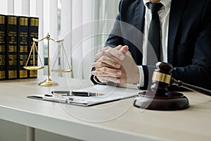 Professional man lawyers work at a law office There are scales, Scales of justice, judges gavel, and litigation documents.