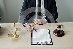 Professional man lawyers work at a law office There are scales, Scales of justice, judges gavel, and litigation documents.