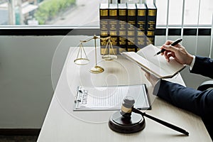 Professional man lawyers work at a law office There are scales, Scales of justice, judges gavel, and litigation documents.