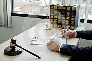 Professional man lawyers work at a law office There are scales, Scales of justice, judges gavel, and litigation documents.