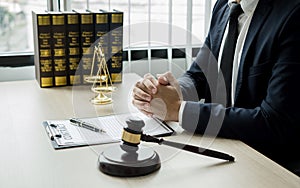 Professional man lawyers work at a law office There are scales, Scales of justice, judges gavel, and litigation documents.