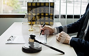 Professional man lawyers work at a law office There are scales, Scales of justice, judges gavel, and litigation documents.