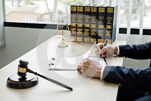 Professional man lawyers work at a law office There are scales, Scales of justice, judges gavel, and litigation documents.