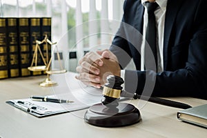 Professional man lawyers work at a law office There are scales, Scales of justice, judges gavel, and litigation documents.