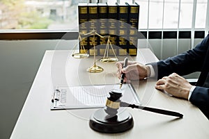 Professional man lawyers work at a law office There are scales, Scales of justice, judges gavel, and litigation documents.