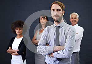 Professional man, leadership and arms crossed in studio for teamwork, confidence or support on wall background. Serious