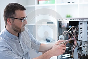 Professional man repairing and assembling a computer