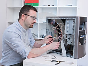 Professional man repairing and assembling a computer