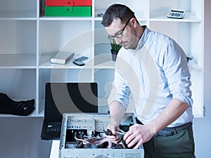 Professional man repairing and assembling a computer