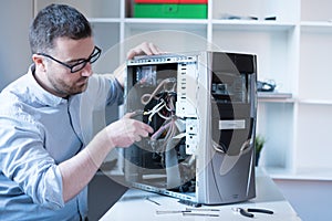 Professional man repairing and assembling a computer