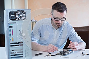 Professional man repairing computer