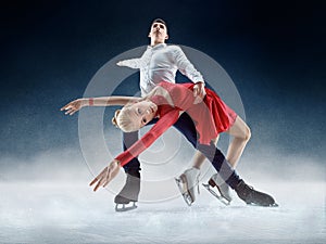 Professional man and woman figure skaters performing on ice show