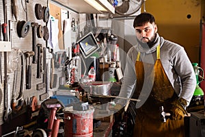 Professional man worker during work with steel in workshop