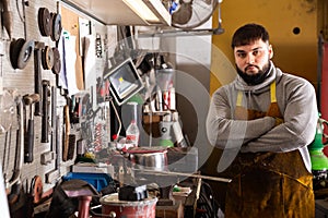 Professional man worker during work with steel in workshop