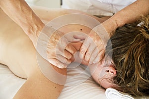 Professional massages to a woman in her neck and back
