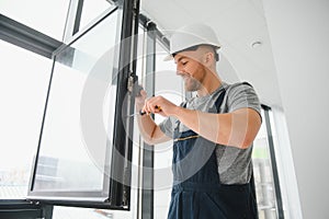 Professional master at repair and installation of windows, at work