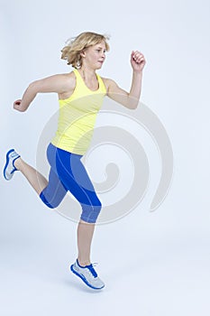 Professional Mature Running Sportswoman in Jogging Outfit in High Jump Against White Background