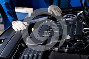 Professional mechanic checking car engine