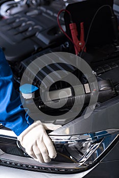 Professional mechanic examining car engine