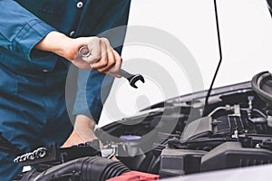 Professional mechanic hand providing car repair and maintenance service