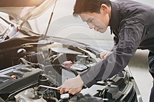 professional mechanic male check fix service car engine in garage auto workshop