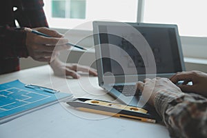 Professional Mechanical Engineer team Working on Personal Computer at Metal lathe industrial manufacturing factory. Engineer