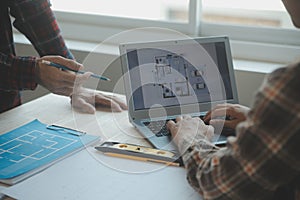 Professional Mechanical Engineer team Working on Personal Computer at Metal lathe industrial manufacturing factory. Engineer